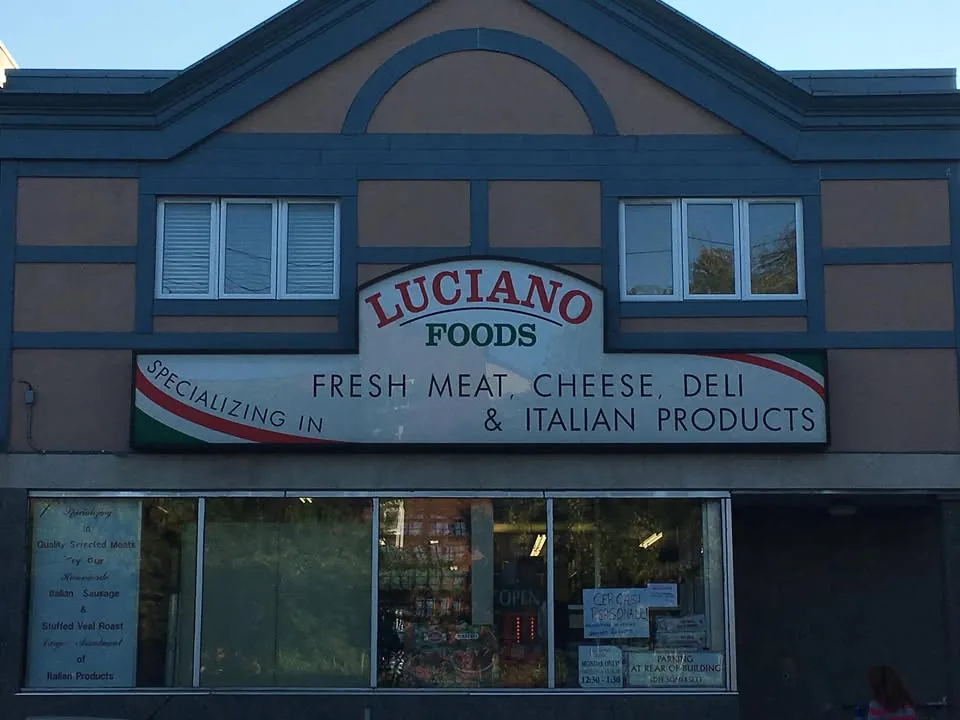 Luciano Foods storefront with the 'Fresh Meat, Cheese, Deli & Italian Products' sign